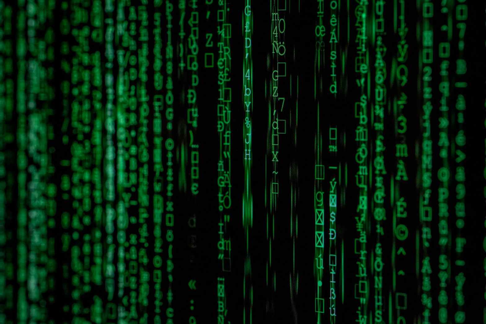 Green digital code cascading down a black screen, evoking a Matrix-style effect—symbolizing the pervasive and complex influence of social media on human behavior and perception.